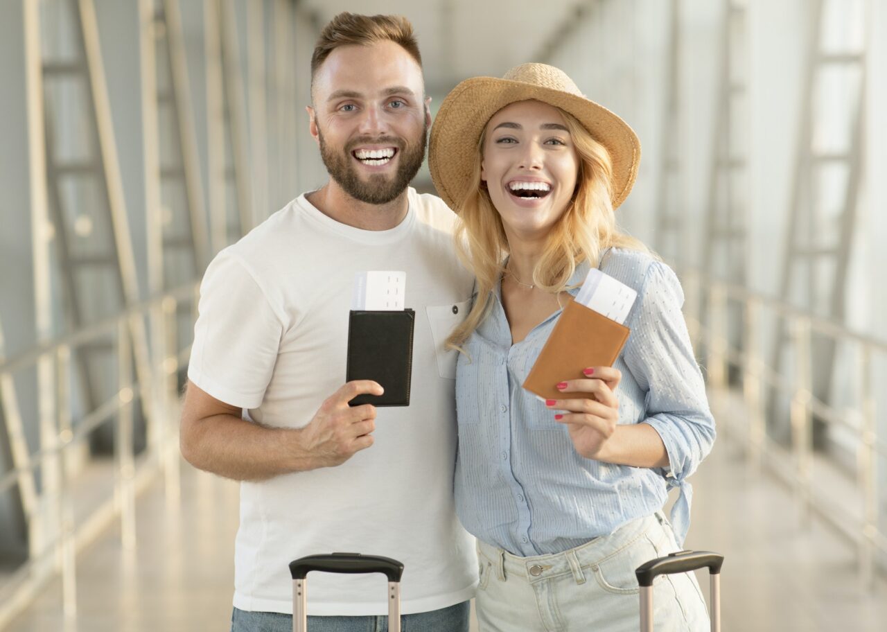 happy couple with passports and tickets at airport terminal x